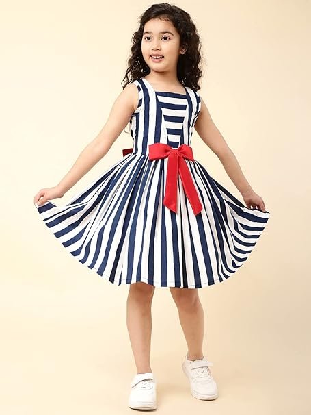 A little girl smiling in a navy blue striped fit and flare party dress, spinning and showing the full skirt.