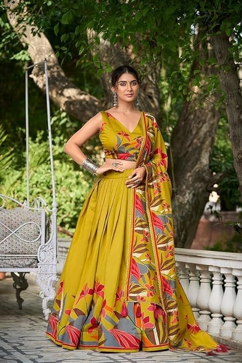 Mustard yellow Tussar Silk lehenga with traditional Patola print and gold foil work for Navratri puja and wedding ceremonies.