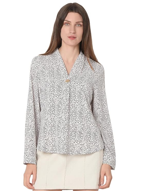Woman in a deep burgundy V-neck long sleeve top with button accents on the cuffs.