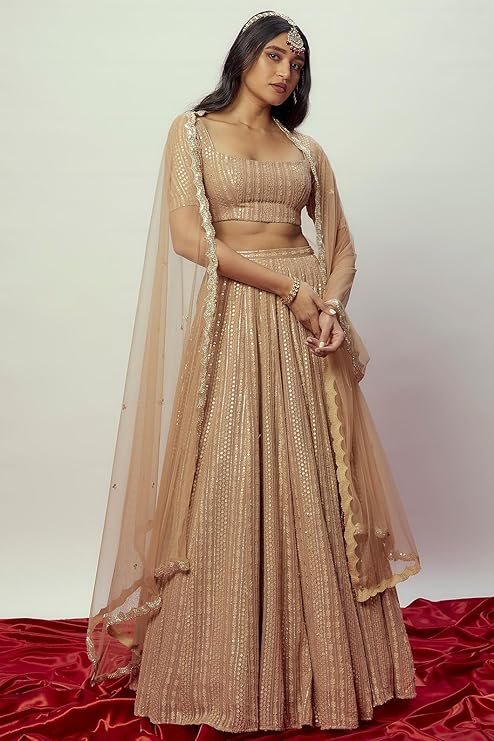 A bright mustard yellow chaniya choli with detailed mirror work and blue embroidery on georgette fabric.