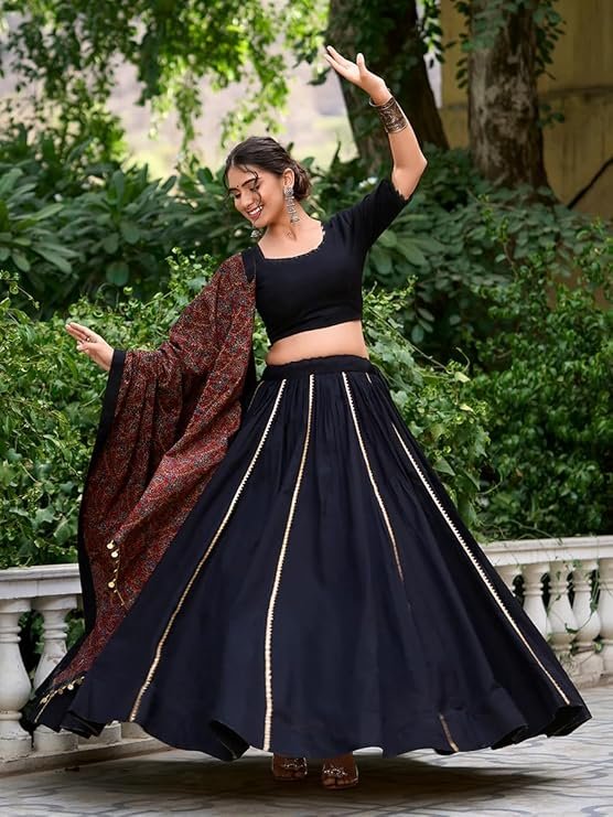 Black rayon Navratri chaniya choli with hand-badhani work dupatta and mirror embroidery for Garba dancing.