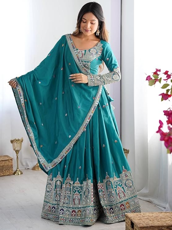 Teal green silk lehenga set with traditional coding dori and sequence embroidery, ideal for wedding guests and festive party wear.