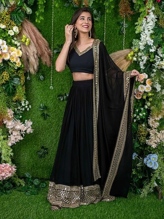 Black rayon Navratri chaniya choli with hand-badhani work dupatta and mirror embroidery for Garba dancing.